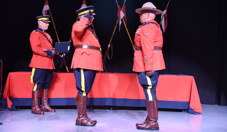 Photo of Corporal J.R. Gohn saluting Chief Superintendent Brian Edmonds.