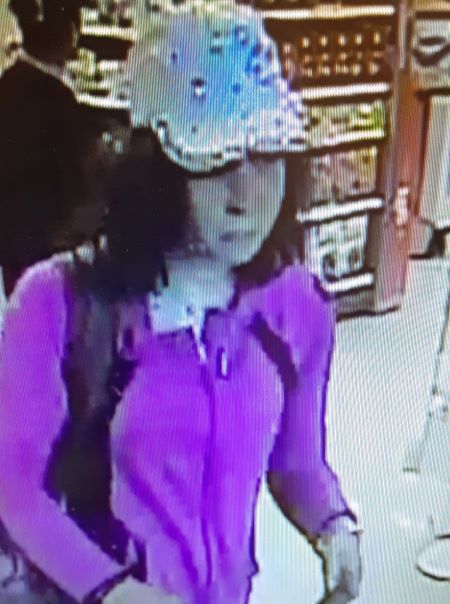 A front image of the suspect wearing a purple tracksuit and light-coloured ball cap. 