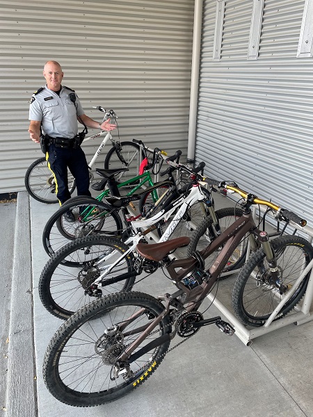 Sgt. Scott Powrie standing in front of bikes.