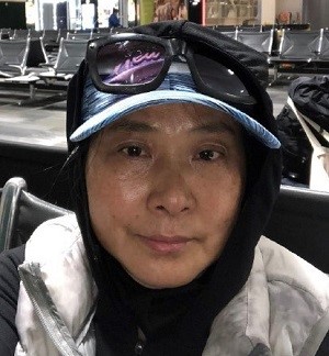 missing person Asian woman in hat with glasses on top