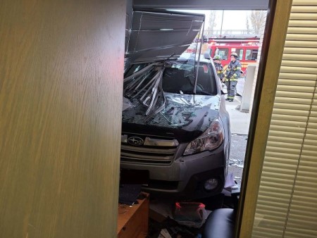 Vehicle in office picture taken from inside with fire fighters in the background