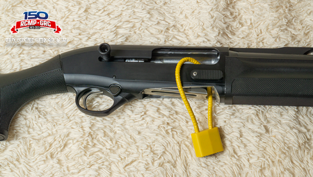 Photo of a shotgun with a cable lock properly installed