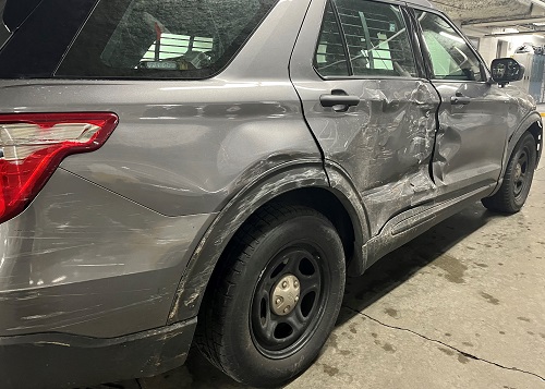 Vehicle damage to back-passenger wheel area of police car